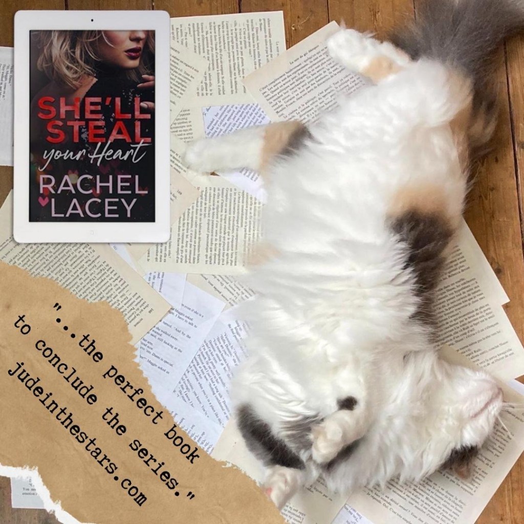 On a backdrop of book pages, an iPad with the She'll Steal Your Heart by Rachel Lacey. Next to it is my very cute and fluffy calico cat Ginny, happily lounging on the pages. At the bottom of the image, on the left-hand side, a strip of torn paper with a quote: "the perfect book to conclude the series" and a url: judeinthestars.com