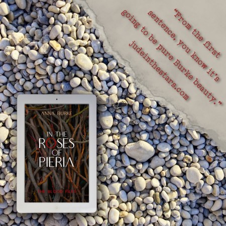 On a backdrop of book pages, an iPad with the cover of In the Roses of Pieria by Anna Burke. In the top right corner of the image, a strip of torn paper with a quote: "From the first sentence, you know it's going to be pure Burke beauty." and a URL: judeinthestars.com.