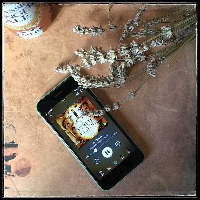 On a beige, ancient-looking background, an iPhone with the cover of